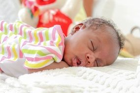 photo of sleeping african baby