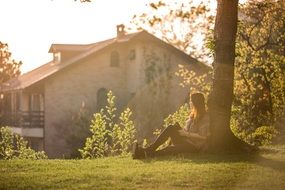 girl under a tree in the sun