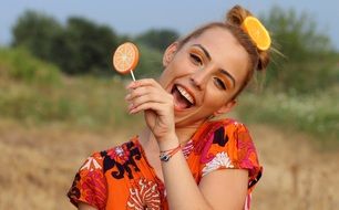 blonde woman with lollipop on a blurred background