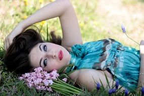dark hair girl posing on spring meadow