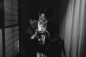 black and white photo of a man with a cigarette in Japan