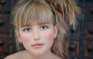 portrait of a girl with blond hair and green eyes