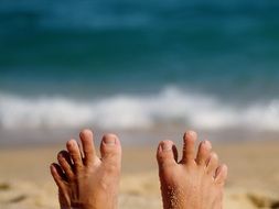 Feet on a sand beach