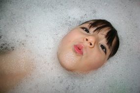 child in the bathroom with foam