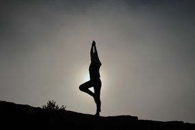 monochrome picture of yoga pose in sunset glow