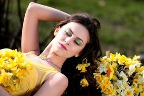 woman with closed eyes with daffodils bouquet