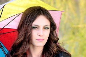 lovely girl under a multi-colored umbrella