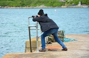 a man photographs the sea