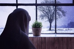 a woman in a headscarf rear view