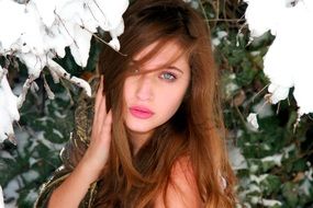 portrait of a beautiful girl with pink lips among nature