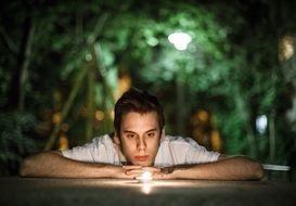 young man relaxes with candles