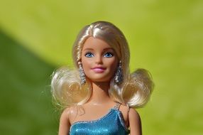 Barbie doll with white hair on a green background