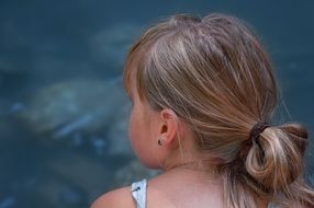 little girl close near the water