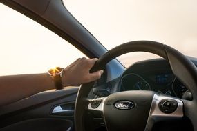 Man with the watch driving the car