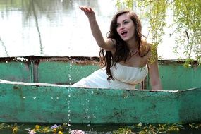 young woman in the boat splashing water