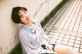 a girl with short hair on the roof of a building