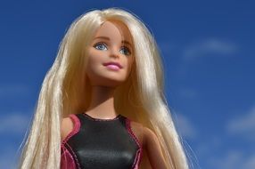 Barbie doll with white hair against the blue sky