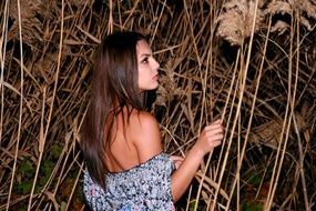 beautiful girl near high reed