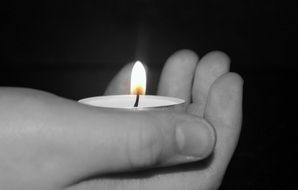 man is holding a candle