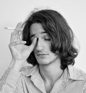 black and white photo of a man with a cigarette in his hand