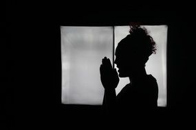 girl silhouette with folded hands