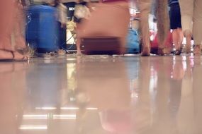 people walk around the airport with their Luggage