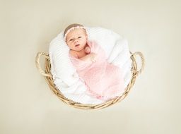 newborn baby girl in a big basket