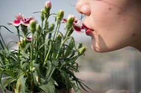 young woman smelling flowers