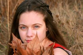 photo of girl with autumn leaves