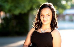 girl in a black dress on a sunny day