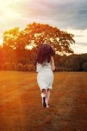 the girl runs through the autumn field