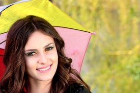 brown-haired girl with colorful umbrella