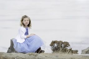 little girl in a beautiful dress in winter