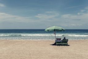 Relaxation, People on ocean Beach under umbrella