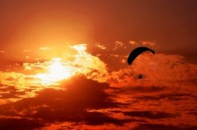 paragliding in orange sunset