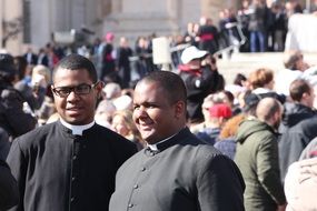 priests in the square with people