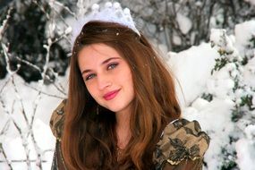portrait of a beautiful girl among the snowy landscape