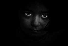 portrait of a girl with beautiful eyes in the dark