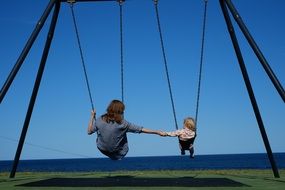 mother and child on Swing in Park