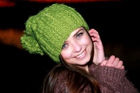 portrait of a smiling girl in a green hat