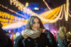 girl outdoors under christmas lights