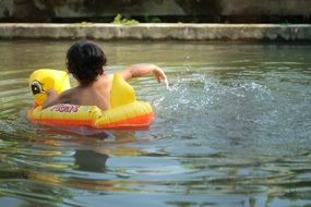 child in the pool in summer