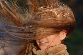 beautiful girl with long hair in the wind