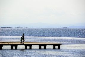 mother and son on the jetty at the mediterranean sea