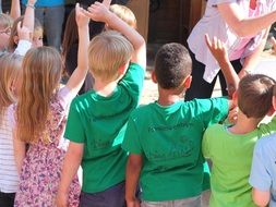 children play outdoor game together in kindergarten