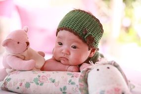 photo of a newborn with a toy
