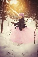baby girl dancing on the background of a winter sunset