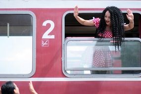 woman saying goodbye from the coach