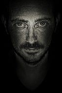 black and white portrait of a darkened face of a man