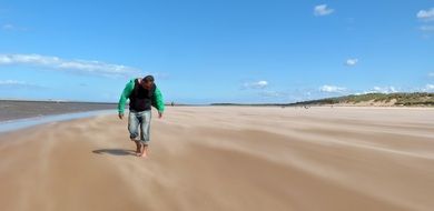 Man walking on a sand beach